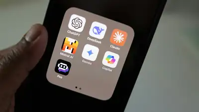 A hand holding a smartphone displaying a folder of AI apps including ChatGPT, DeepSeek, Claude, Mistral AI, Gemini, Copilot, and Poe. Photo by Solen Feyissa.